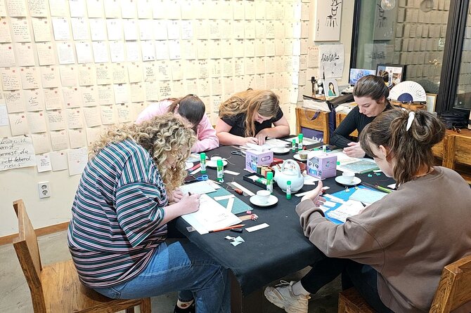 Create a Handmade Traditional Korean Notebook in Insadong - The binding process: folding, hole punching, and needle-and-thread stitching